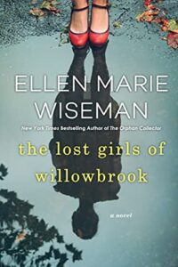 The Lost Girls of Willowbrook by Ellen Marie Wiseman Book Cover  with woman looking at her reflection in lake