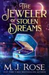 The Jeweler of Stolen Dreams book cover with blue suitcase holding a ring inside