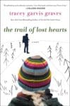 The Trail of Lost Hearts by Tracey Garvis Graves book clove with white snowy background with the back of a woman's head in a ski cap.