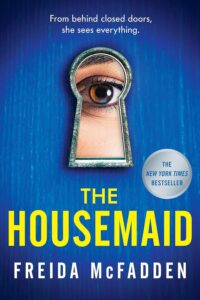 The Housemaid by Freida McFadden book cover featuring a blue door w a girl's face looking through a keyhole