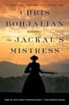 The Jackal's Mistress by Chris Bohjalian book cover with sunset over the mountains and a woman's silhouette holding a rifle